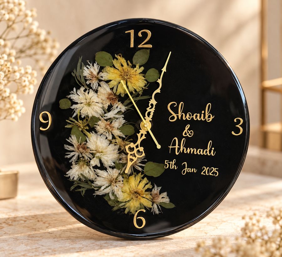 Black round resin clock decorated with preserved flowers and personalized lettering